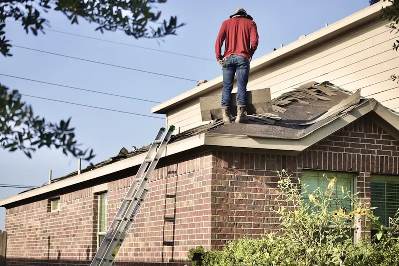 Professional roofer working on a residential roof in Allatoona Pass